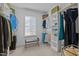 Well-organized walk-in closet with ample shelving, hanging space, and natural light at 155 Georgetown Woods Dr, Youngsville, NC 27596