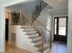 Welcoming foyer showcases a staircase with wood and iron railings, and a front door with sidelight window at 1585 Lavington Pl, Apex, NC 27502