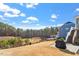 Expansive backyard featuring a pond, trees, patio, and plenty of space for outdoor activities and relaxation at 169 Hidden Bluff Dr, Chapel Hill, NC 27517