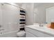 Bright bathroom with a tub, shower, vanity with sink, and a large mirror with neutral tones at 169 Hidden Bluff Dr, Chapel Hill, NC 27517