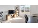 Bedroom with a television, closet and a large window providing natural light at 169 Hidden Bluff Dr, Chapel Hill, NC 27517