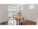 Dining area with light colored wooden table and chairs with access to an outdoor patio at 169 Hidden Bluff Dr, Chapel Hill, NC 27517