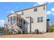 Rear exterior view of a home, featuring a screened porch and deck with stairs, connecting indoor and outdoor spaces at 169 Hidden Bluff Dr, Chapel Hill, NC 27517