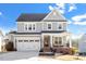 Charming two-story home featuring a welcoming front porch and attached two-car garage at 169 Hidden Bluff Dr, Chapel Hill, NC 27517