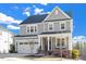 Beautiful two-story home with gray siding, a cozy front porch, and an attached garage at 169 Hidden Bluff Dr, Chapel Hill, NC 27517