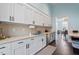 Bright kitchen features white cabinets, modern hardware, stainless steel appliances, and durable countertops at 169 Hidden Bluff Dr, Chapel Hill, NC 27517