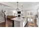 Open-concept kitchen with a large island, stainless steel appliances, and hardwood floors at 169 Hidden Bluff Dr, Chapel Hill, NC 27517