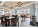 Bright lounge area with large windows, tables, and chairs for gatherings at 169 Hidden Bluff Dr, Chapel Hill, NC 27517
