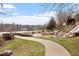 A scenic pond with a waterfall and walking path at 169 Hidden Bluff Dr, Chapel Hill, NC 27517