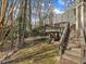 Exterior showing the deck with stairs and a view into the treed backyard at 1710 Falls Church Rd, Raleigh, NC 27609