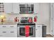 Close-up of a kitchen with stainless steel appliances, granite countertops, and modern fixtures at 1710 Falls Church Rd, Raleigh, NC 27609