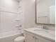 This bathroom features a shower-tub combination, white marble countertops, and bright lighting at 1800 Bright Lantern Way, Wendell, NC 27591