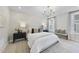 A neutral bedroom has a chandelier, window, and two bedside tables at 1800 Bright Lantern Way, Wendell, NC 27591
