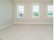 Spacious bedroom with neutral carpet and three large windows offering an abundance of natural light at 1800 Bright Lantern Way, Wendell, NC 27591