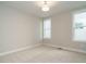 This bedroom features carpeted floors and bright, natural light from multiple windows at 1800 Bright Lantern Way, Wendell, NC 27591