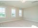 This is a bedroom with neutral carpet and two bright windows at 1800 Bright Lantern Way, Wendell, NC 27591