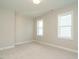 This is a bedroom with neutral carpet and two bright windows at 1800 Bright Lantern Way, Wendell, NC 27591