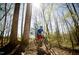 A young cyclist enjoys a ride on the community's scenic bike trails in a lush wooded area at 1800 Bright Lantern Way, Wendell, NC 27591