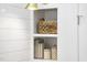 Close-up of built-in shelves with decorative baskets, books, and charming jars for a cozy and organized look at 1800 Bright Lantern Way, Wendell, NC 27591