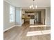 Open-concept dining room leading to a kitchen with stainless steel appliances and a kitchen island at 1800 Bright Lantern Way, Wendell, NC 27591