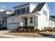 Charming two-story home featuring a white exterior, attached garage, and inviting front porch at 1800 Bright Lantern Way, Wendell, NC 27591
