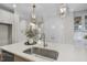 Close-up of kitchen island, featuring a sink, quartz countertops, and stainless steel fixtures at 1800 Bright Lantern Way, Wendell, NC 27591