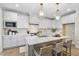 Stylish kitchen island featuring bar stool seating, with pendant lighting and white cabinets at 1800 Bright Lantern Way, Wendell, NC 27591