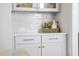 Detailed view of a modern kitchen cabinet with white subway tile backsplash and stylish countertop decor at 1800 Bright Lantern Way, Wendell, NC 27591