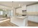 Open concept kitchen with granite counters, stainless appliances, island and view to living area at 1800 Bright Lantern Way, Wendell, NC 27591