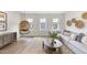 Comfortable living room featuring a hanging chair, stylish decor, and wood flooring at 1800 Bright Lantern Way, Wendell, NC 27591