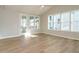 Bright living room featuring wood floors, a vaulted ceiling, multiple windows and access to a balcony at 1800 Bright Lantern Way, Wendell, NC 27591