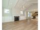 Open-concept living room with vaulted ceilings, fireplace, and access to kitchen and dining at 1800 Bright Lantern Way, Wendell, NC 27591