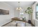 Well-lit office with wood desk, a modern chandelier, and views of the outdoors at 1800 Bright Lantern Way, Wendell, NC 27591