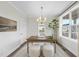 Well-lit office with wood desk, a modern chandelier, and views of the outdoors at 1800 Bright Lantern Way, Wendell, NC 27591