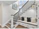 Elegant staircase with wood treads, iron railings, and a cozy bench with storage at 1800 Bright Lantern Way, Wendell, NC 27591