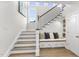 Elegant staircase with wood treads, iron railings, and a cozy bench with storage at 1800 Bright Lantern Way, Wendell, NC 27591