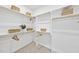 A spacious walk-in closet features open shelving, wooden rods, and carpeted floors at 1800 Bright Lantern Way, Wendell, NC 27591