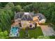 Aerial view of a home featuring a pool, outdoor kitchen, and a basketball court at 1801 Oatlands Ct, Wake Forest, NC 27587