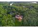 Stunning aerial view of a luxurious home nestled amongst lush greenery and trees, with a pool and meticulously kept lawn at 1801 Oatlands Ct, Wake Forest, NC 27587