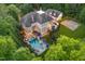 Aerial view of the backyard showcasing the pool, spa, patio, and lush landscaping at 1801 Oatlands Ct, Wake Forest, NC 27587