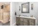 Elegant bathroom with walk-in shower, marble countertop, and modern lighting at 1801 Oatlands Ct, Wake Forest, NC 27587