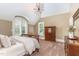 Bedroom with high ceilings, large windows with shutters, and neutral decor at 1801 Oatlands Ct, Wake Forest, NC 27587
