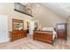 Bedroom with high ceilings and a wooden bed, and a view into an attached bathroom at 1801 Oatlands Ct, Wake Forest, NC 27587