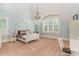 Cozy bedroom with four-poster bed, a chandelier, large window, and a built-in desk at 1801 Oatlands Ct, Wake Forest, NC 27587