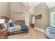 Bedroom with high ceilings and neutral decor featuring a wooden dresser and a globe chandelier at 1801 Oatlands Ct, Wake Forest, NC 27587