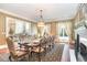 Elegant dining room with fireplace, large windows, and stylish decor at 1801 Oatlands Ct, Wake Forest, NC 27587