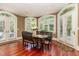 Bright dining room with hardwood floors, many windows, shutters, and access to the porch at 1801 Oatlands Ct, Wake Forest, NC 27587