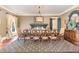 Formal dining room featuring an ornate chandelier and a spacious table at 1801 Oatlands Ct, Wake Forest, NC 27587