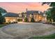 Circular driveway of this stone home featuring a portico leading to a three-car garage at 1801 Oatlands Ct, Wake Forest, NC 27587