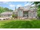 An attractive stone home featuring a portico leading to a three-car garage at 1801 Oatlands Ct, Wake Forest, NC 27587
